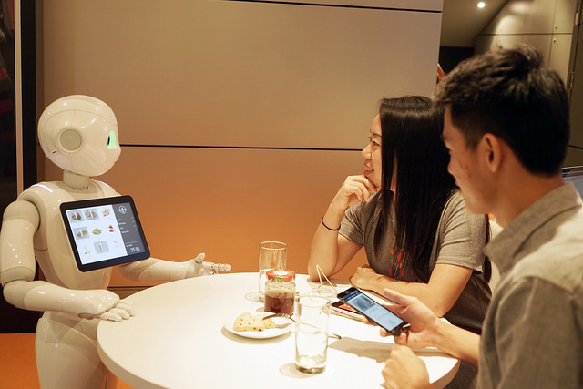 alt="Pepper takes orders from customers at the MasterCard Cafe"